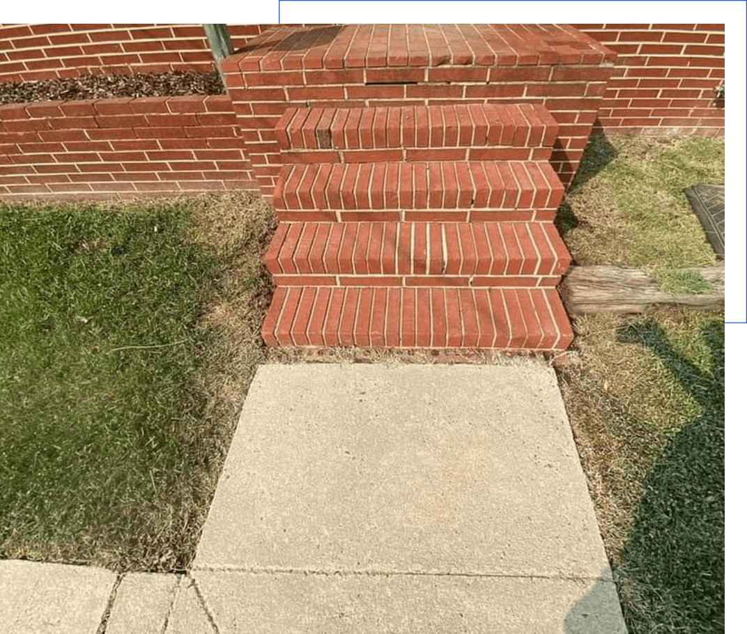 Brick steps with lawn and sidewalk.